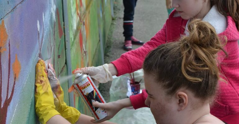 Volunteers painting a wall